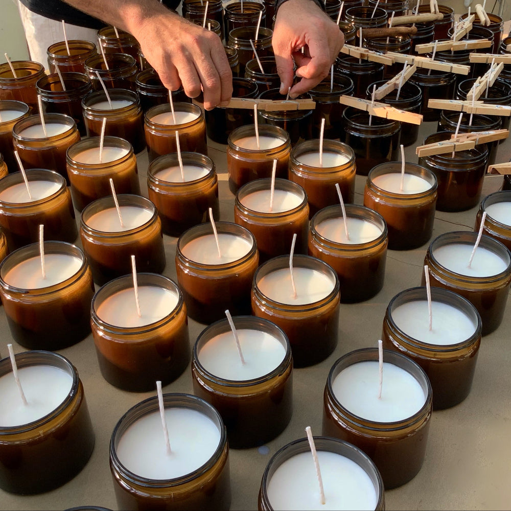 Hand pouring ReCalm Holistic Aromatherapy Essential Oil Candles to Relax, Rejuvenate, Recover and ReCalm your senses