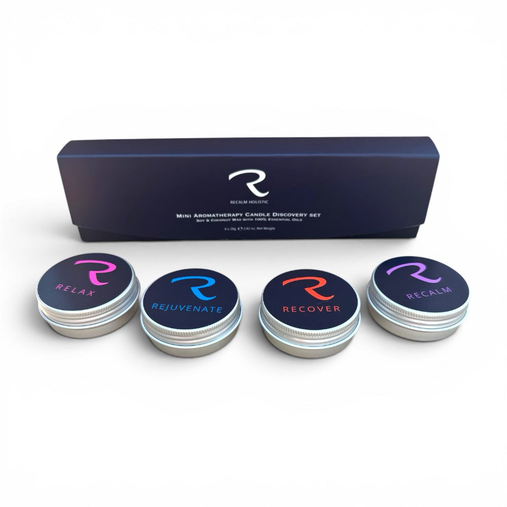 A mini aromatherapy candle discovery set by ReNew Science, featuring a dark navy blue rectangular box and four round silver tin candles with black lids. The lids are labeled 'RELAX', 'REJUVENATE', 'RECOVER', and 'RECHARGE' in pink, blue, orange, and purple colors respectively,