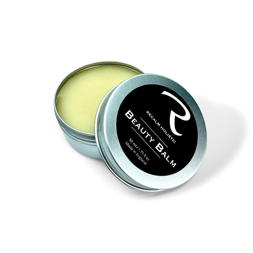 Beauty balm in a metal tin with a black label on a white background