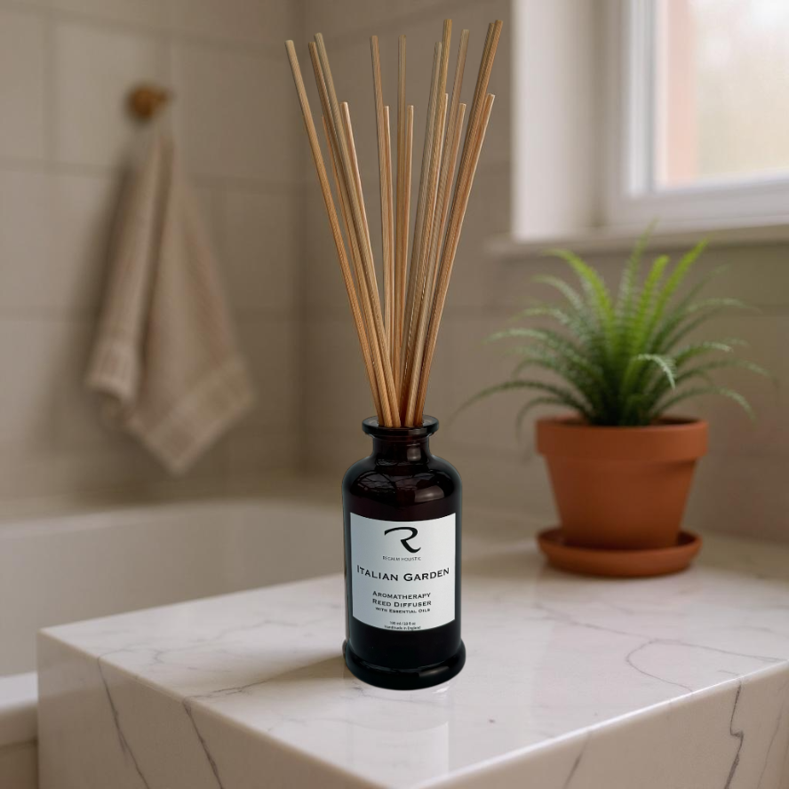 Reed diffuser labeled 'Italian Garden' on a bathroom counter with a plant in the background.