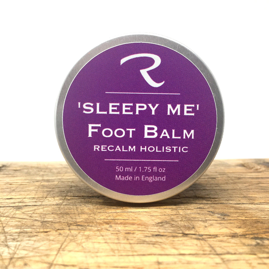 'Sleepy Me' foot balm tin on a wooden surface with a white background
