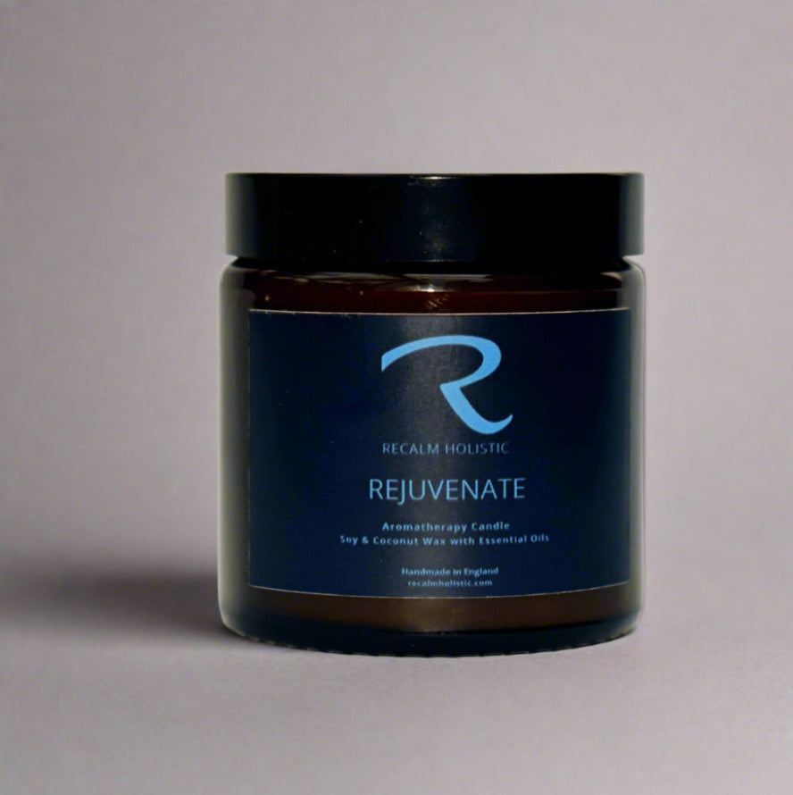 Jar of 'Rejuvenate' candle by Recalm Holistic on a gray background