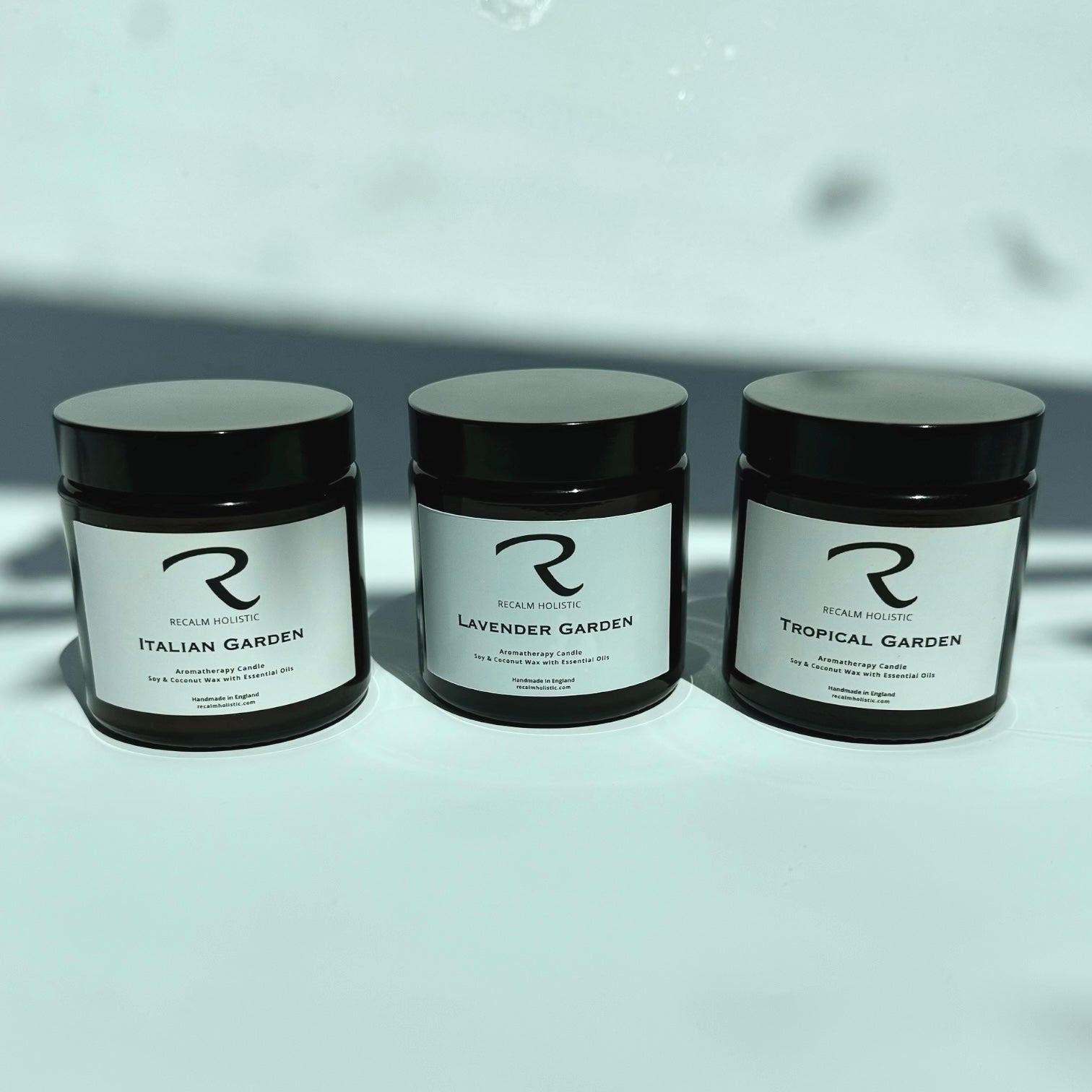 Three jars labeled 'Italian Garden', 'Lavender Garden', and 'Tropical Garden' on a light background.