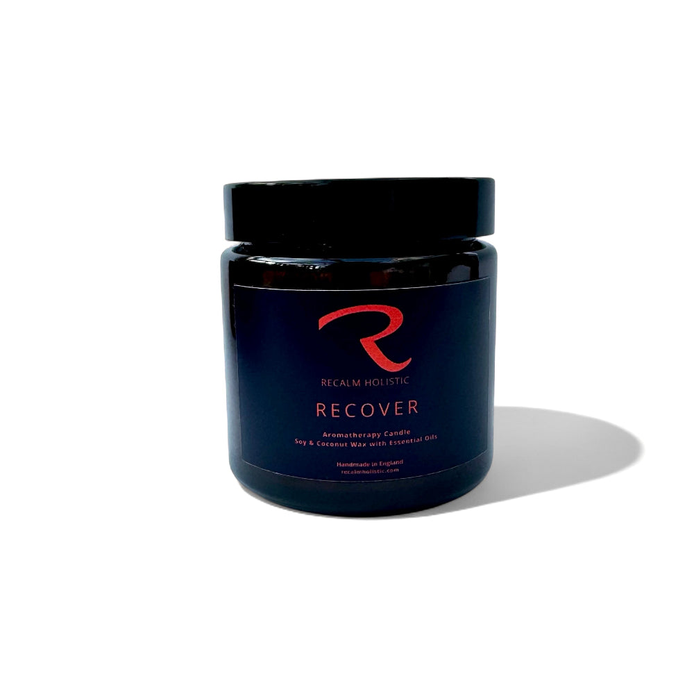 Aromatherapy candle jar labeled 'Recover' by Recall Holistic on a white background