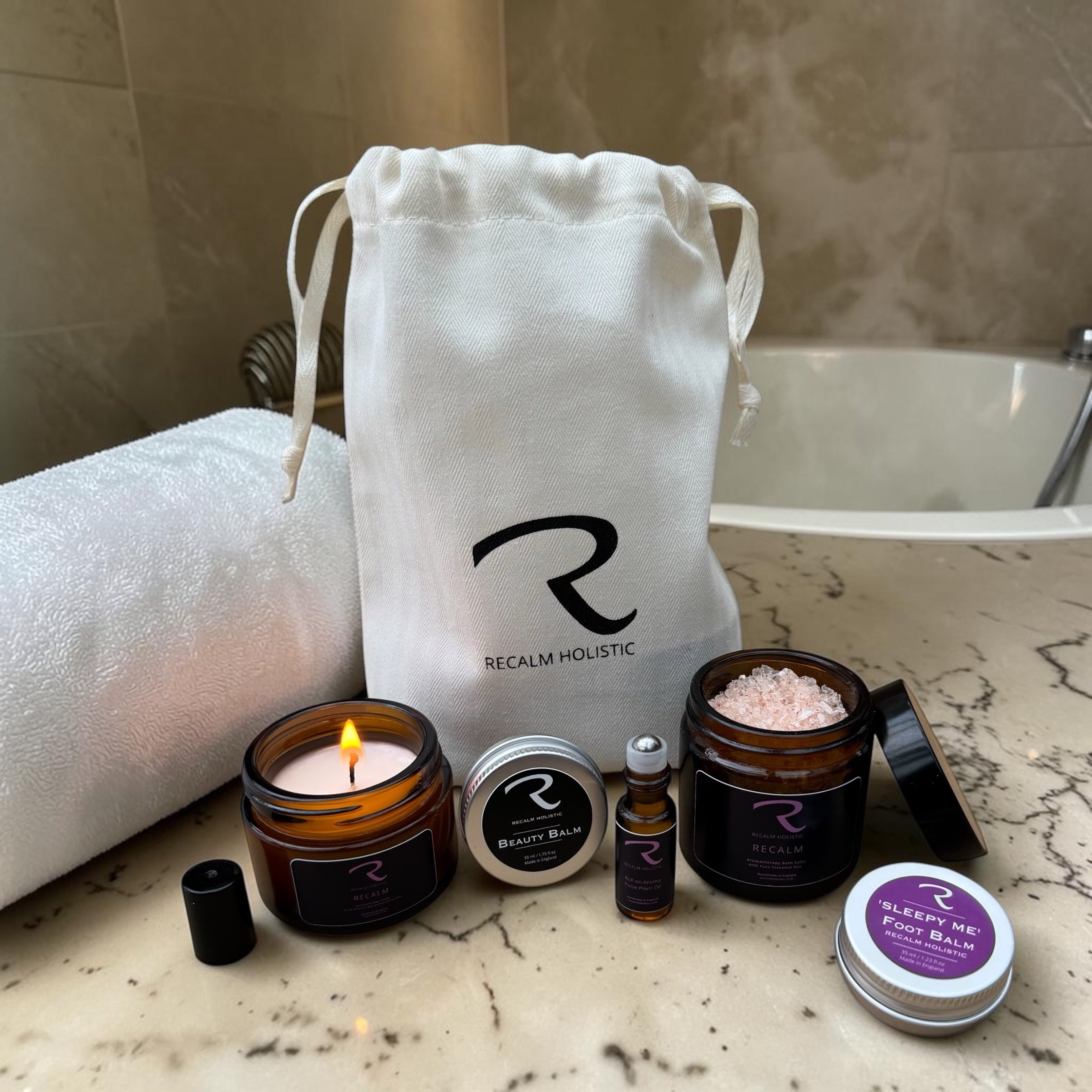 A collection of travel size aromatherapy minis, including pocket-sized essential oil rollers and wellness balms