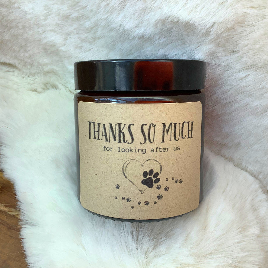 Candle with a label on with paw prints and heart saying Thanks so much 