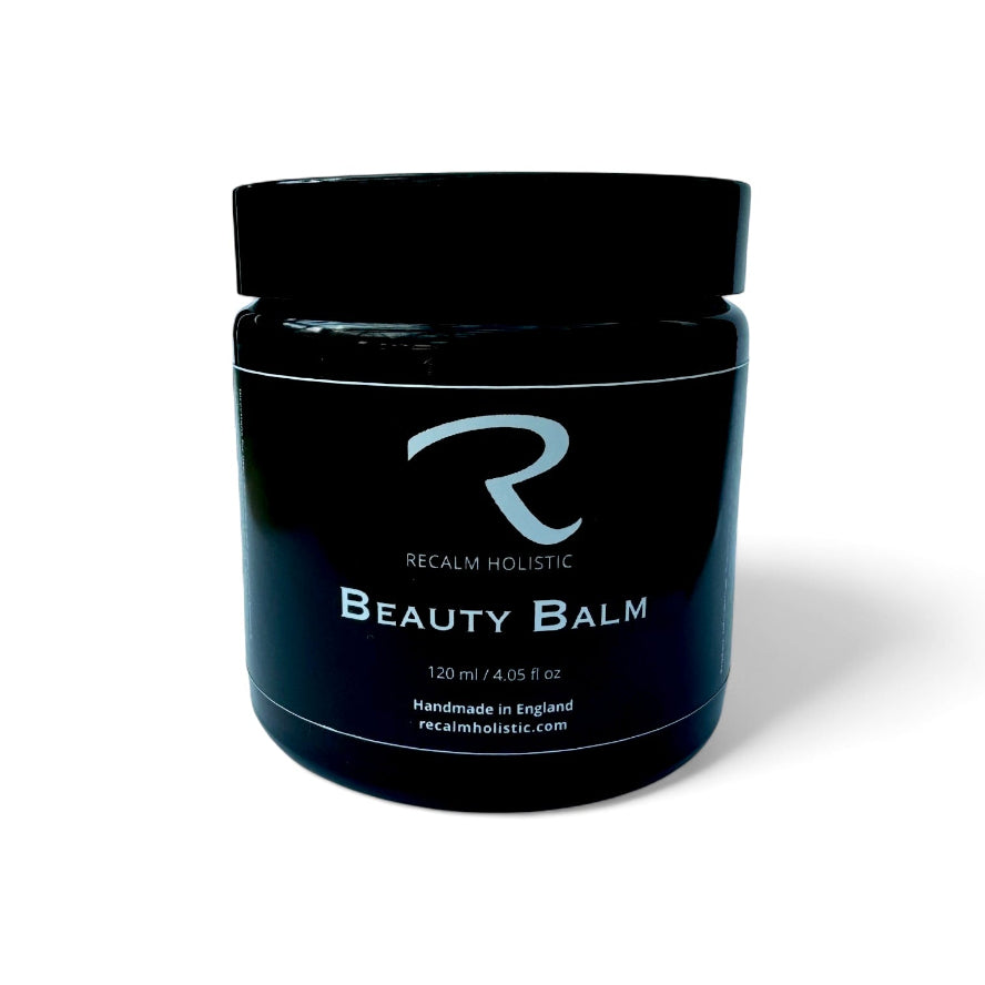 Black jar of Recalm Holistic Beauty Balm on a white background