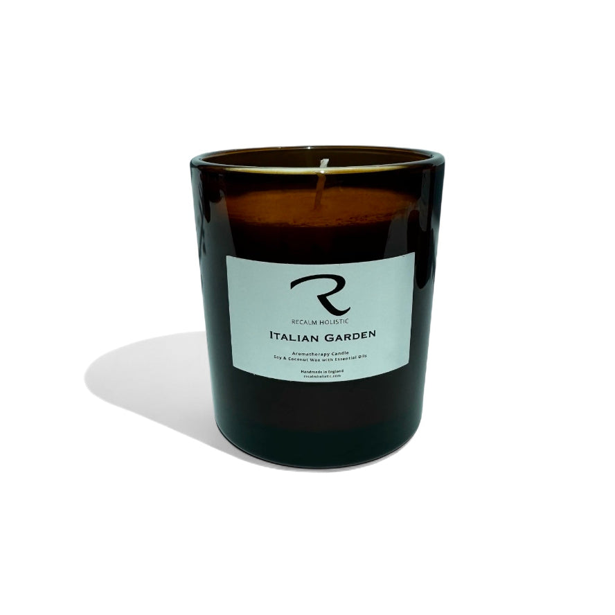 Black candle with a label called Italian Garden Aromatherapy Candle on a white background