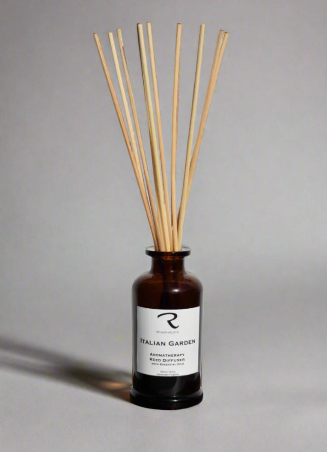 Reed diffuser with wooden sticks in a brown bottle on a gray background