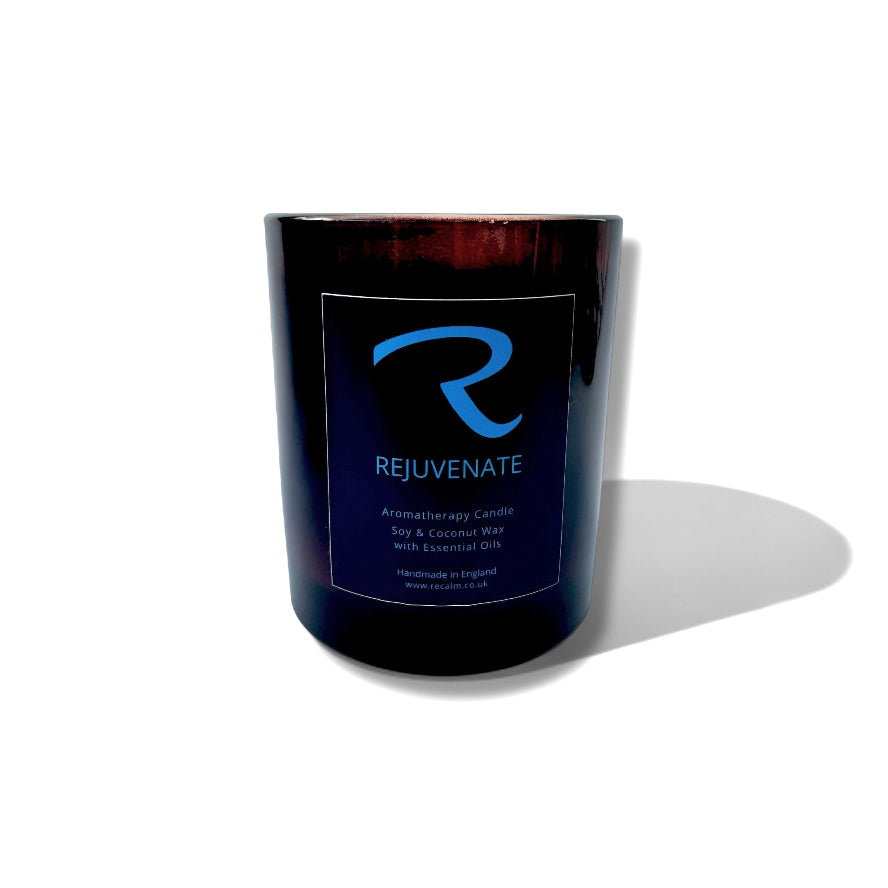 Amber aromatherapy candle with 'Rejuvenate' label on a white background