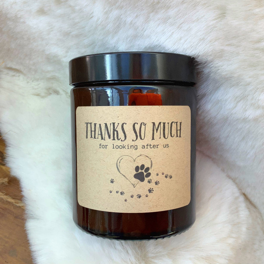 Candle with a label on a fluffy white surface