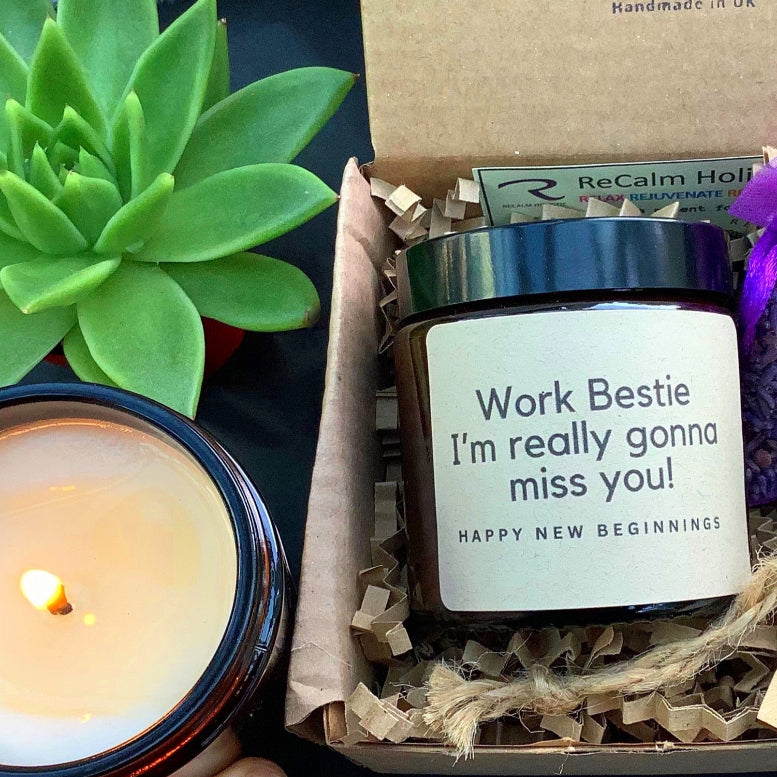 Gift box with candles and items from ReCalm, featuring a lit candle on the side.