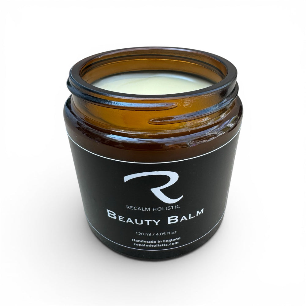 An open jar of ReCalm Beauty Balm showing the smooth natural formula, designed for intensive skin barrier repair and calming severe dryness.