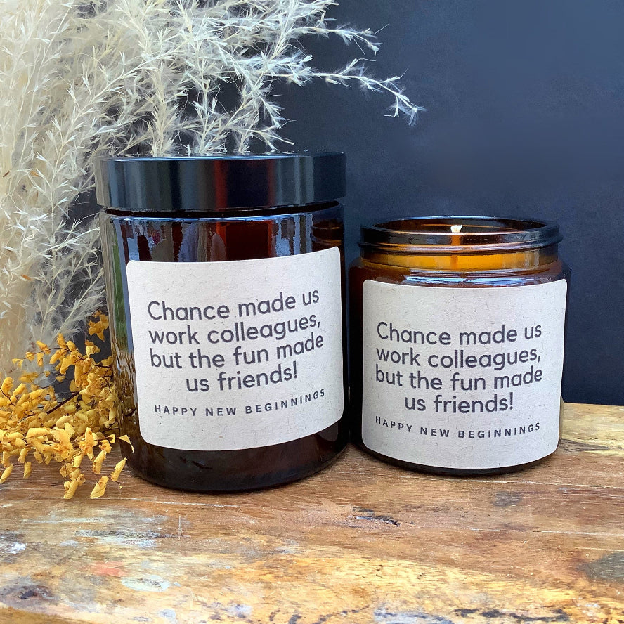 Two jars with motivational labels on a wooden surface with decorative plants.