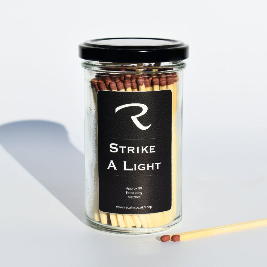 A striking view of Strike a Light extra long wooden candle matches in an elegant glass apothecary jar by ReCalm Holistic.